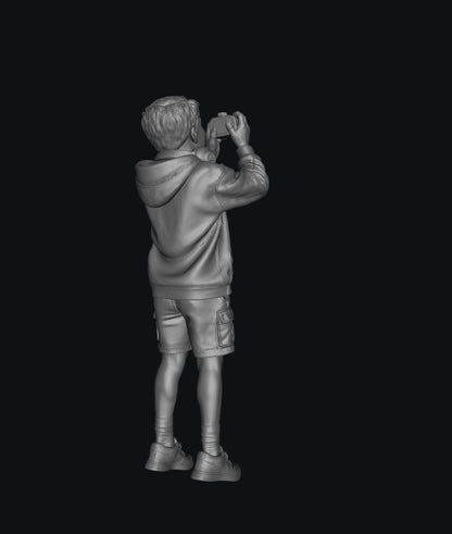 WOSC011 - Young Boy with a Camera