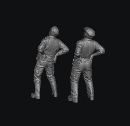 Two unpainted grey resin 3D-printed male farmer figures standing with hands on their lower backs in pain.
