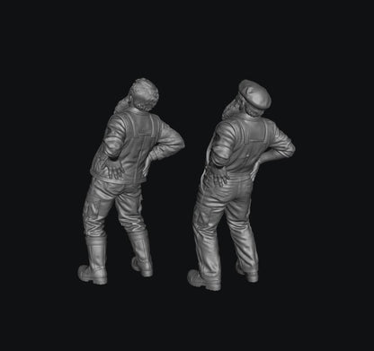 Two unpainted grey 3D-printed resin scale model figures of elderly farmers with back pain, shown from behind.