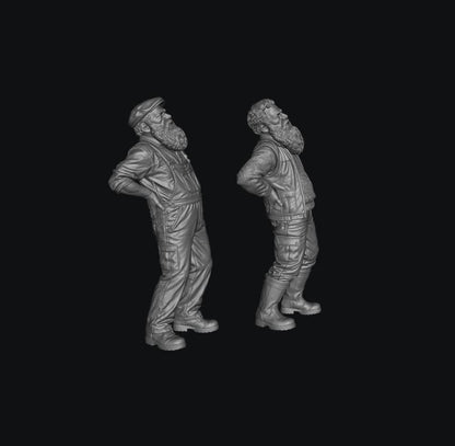 Two unpainted grey resin 3D-printed miniature figures of elderly bearded men with back pain in workwear.